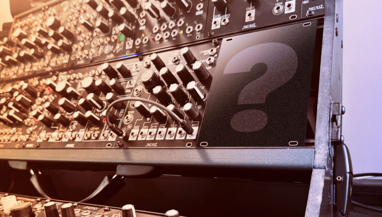 Rack of synth modules with a large question mark panel