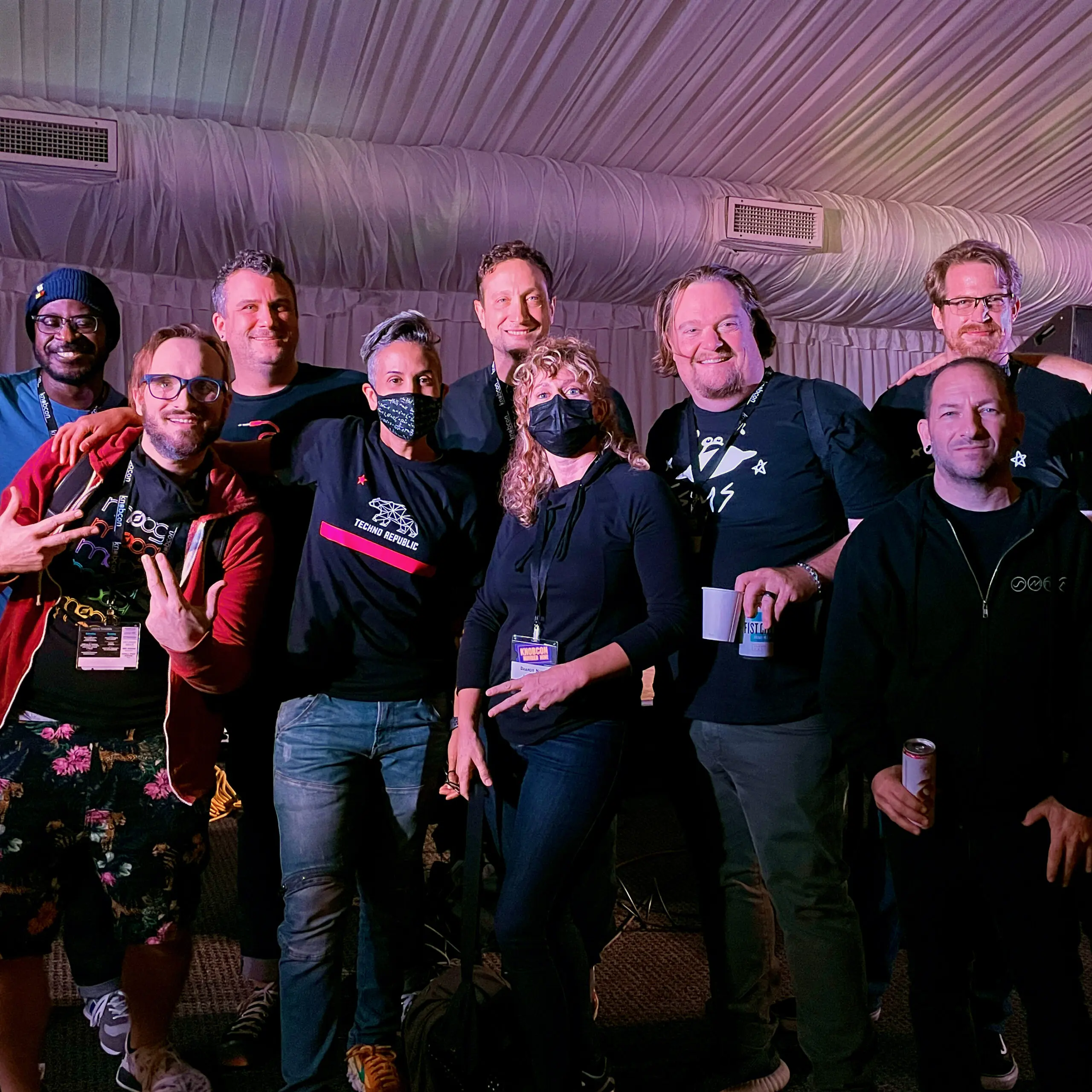 Group photo of modular synth fans at Knobcon under purple lighting